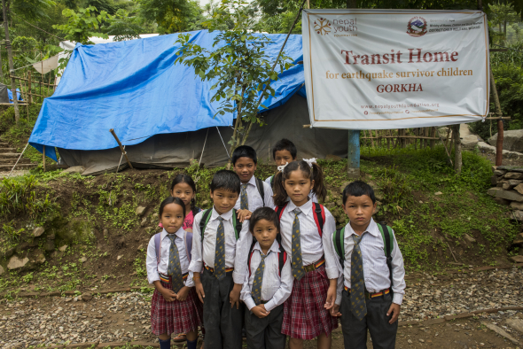 Nepal, Gorkha, Nepal Youth Foundation. Children living in camp at the Nepal Youth Foundation sponsored transit camp for children who have lost parents or relatives during the earthquake. The eat together, do homework together and are begining to attend a newly built local school.
