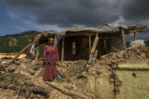 Nepal, Kavre District, Nala, earthquake relief efforts. Visiting destroyed homes on TEWA project supported by Global Fund for Women. Laxmi Dahal (21) and her mother in law, Nirmala, in front of their destroyed home. TEWA is now helping to financially support them.